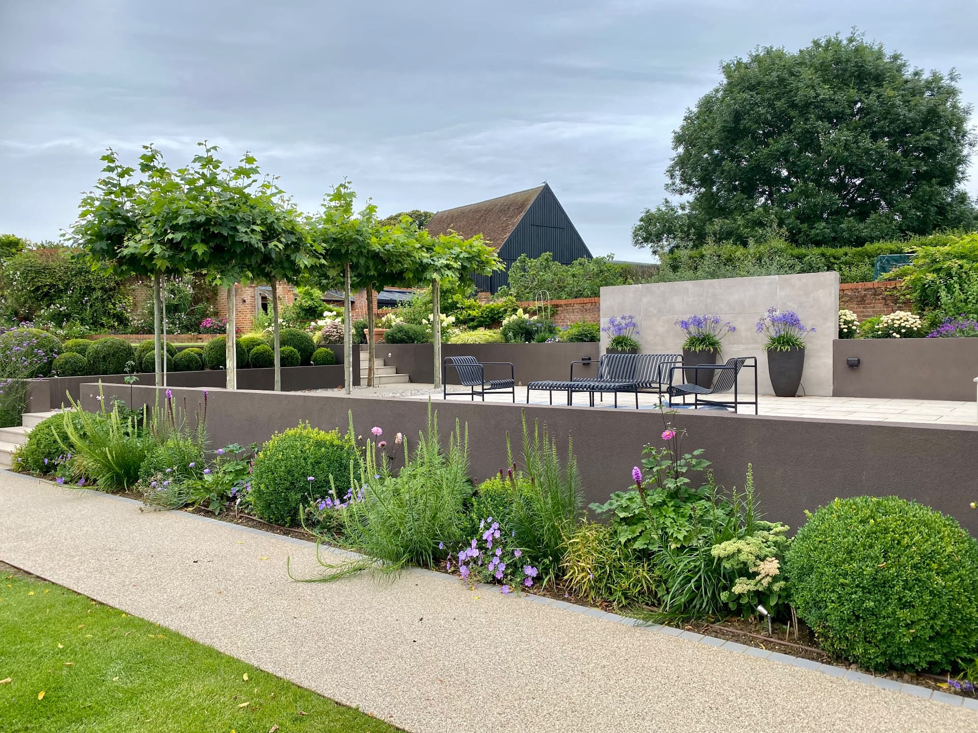 Pale steps, structural trees and layered planting in a Suffolk garden