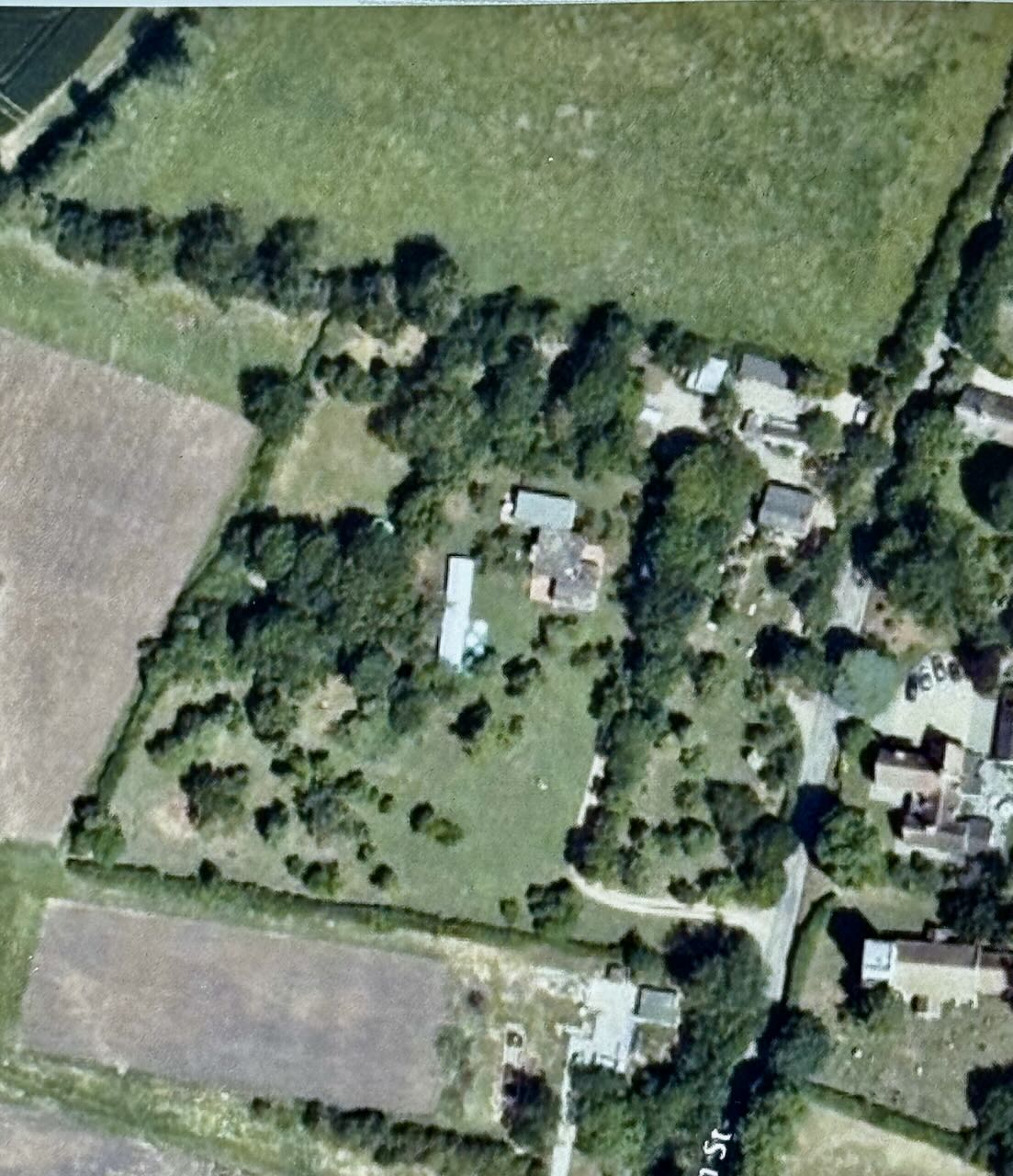 Aerial context showing the house, its orchard and surrounding farmland
