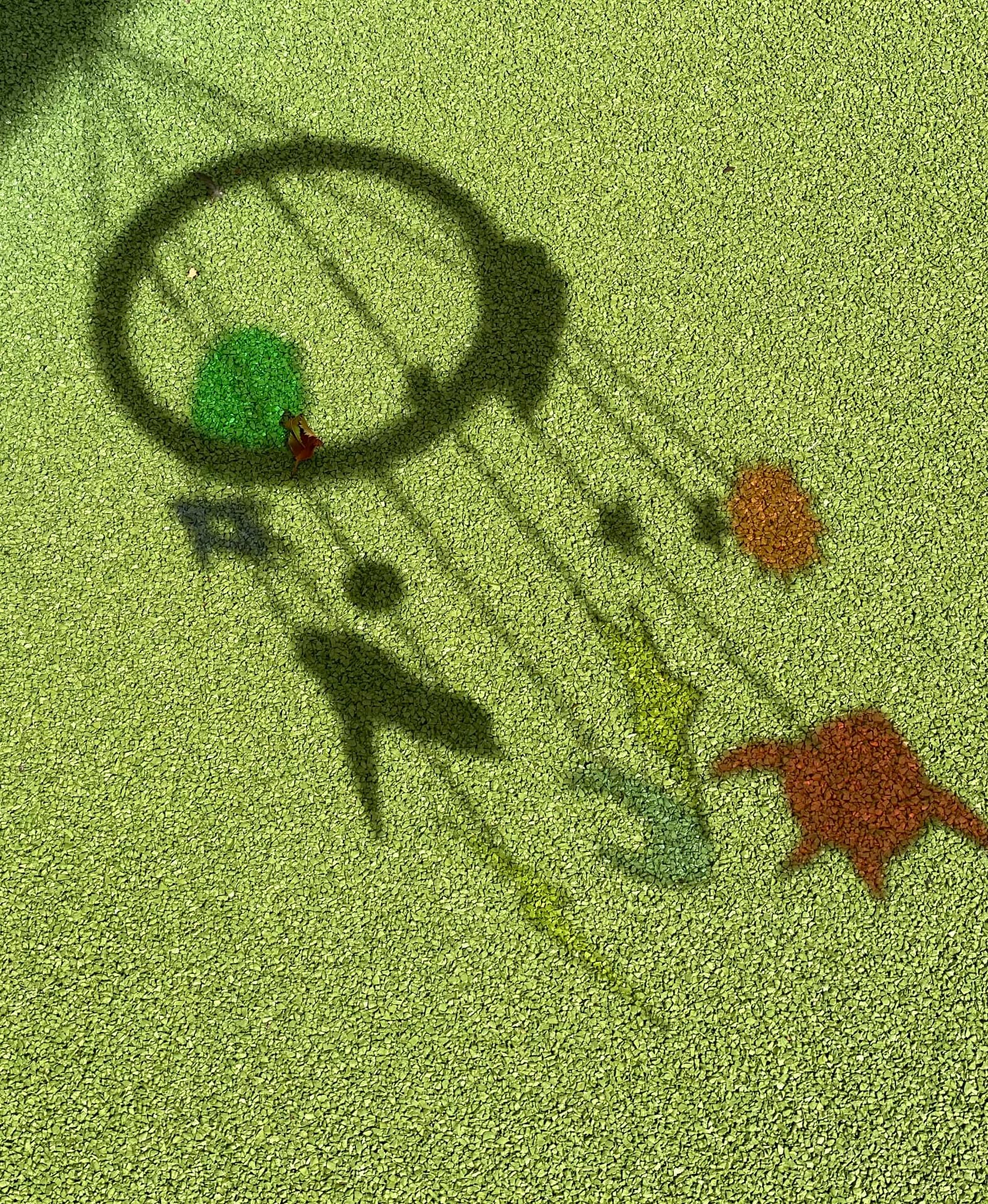 Play-equipment shadows across the grass at Thomas Wolsey Ormiston Academy