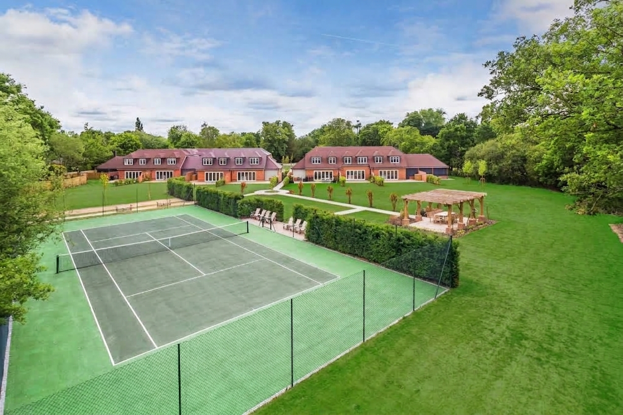 Tennis court, communal lawn, pavilion and housing within the shared landscape